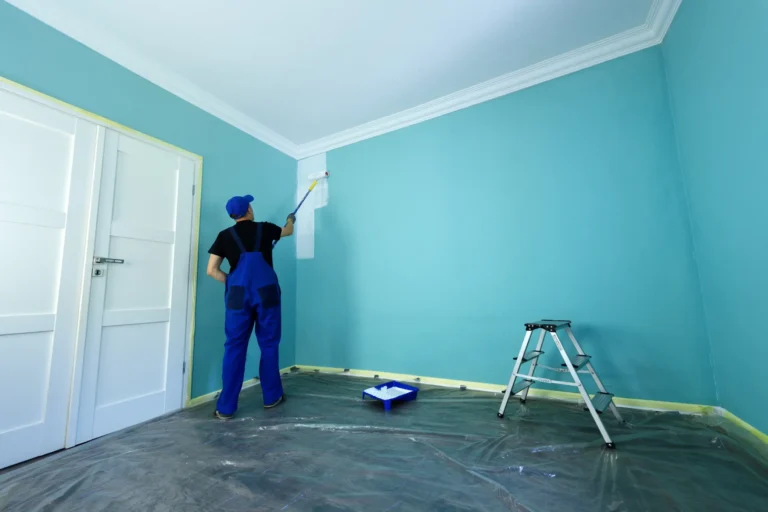 A worker painting the interior of the room.