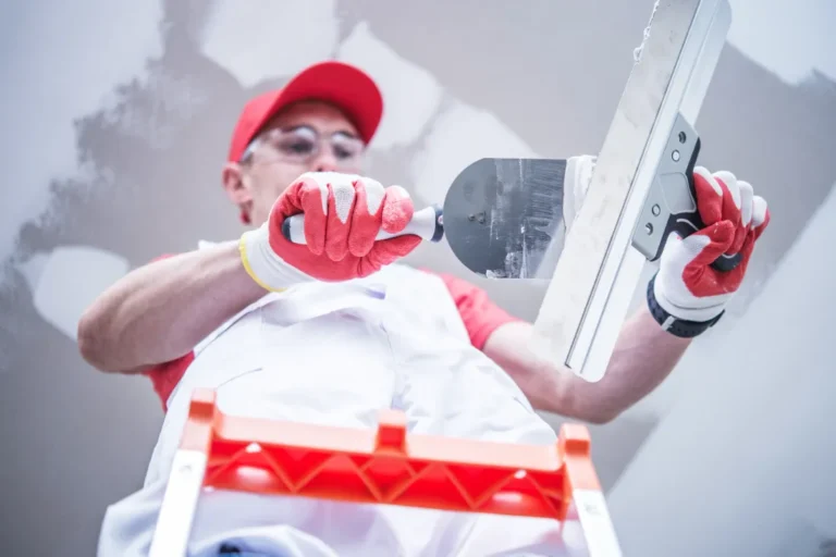 A man preparing for drywall path on the ceiling.